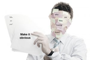 When the obvious isn't obvious. Businessman covered with memos on white background